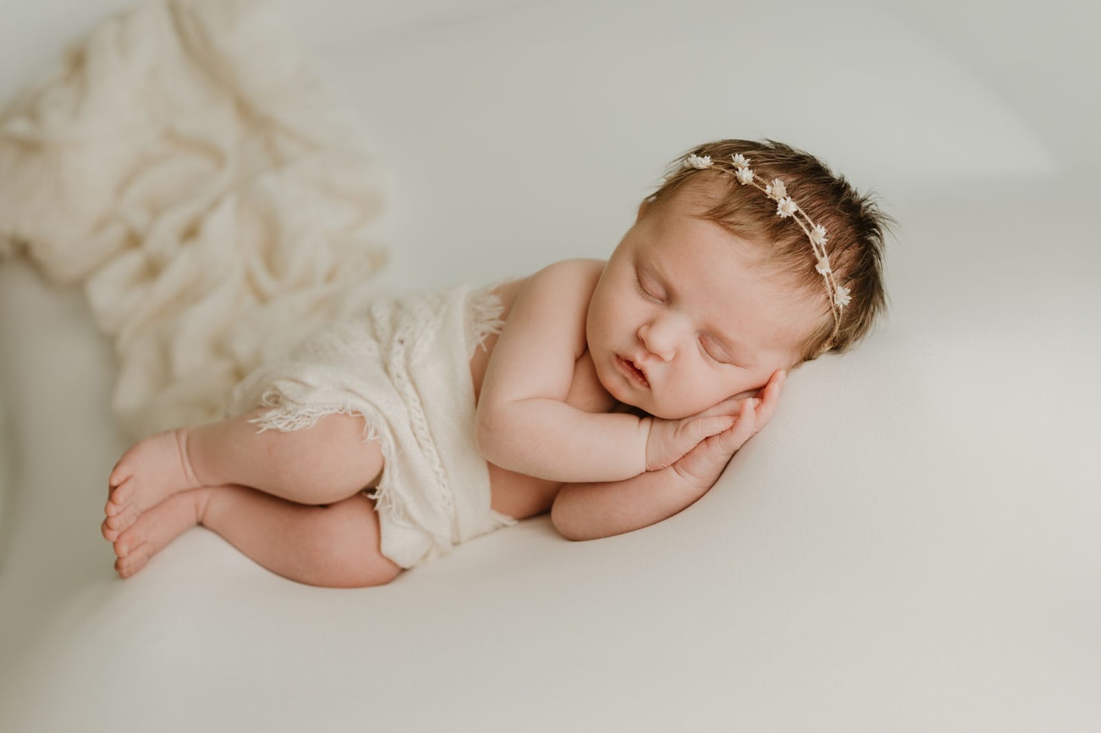 newborn baby sleeping on soft pillows